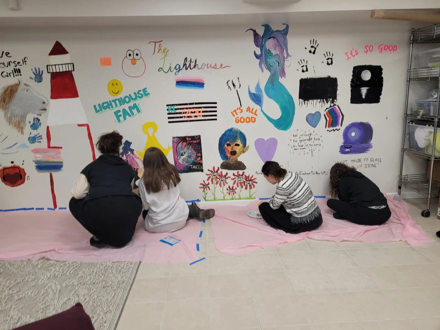 Members creating the Lighthouse community art wall